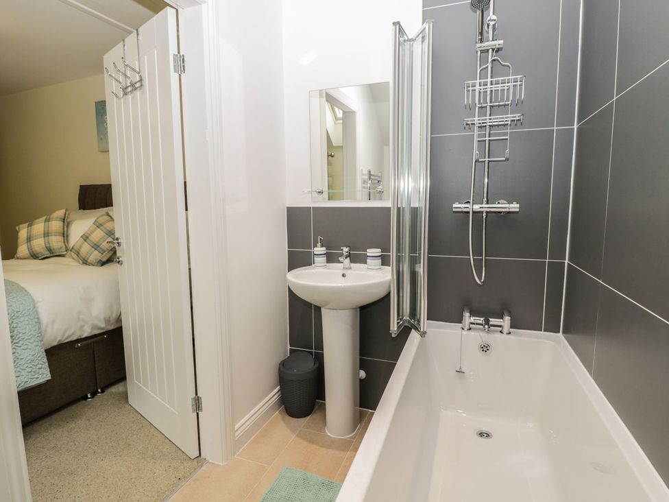 A bathroom with a bathtub and sink at The Turnip Barn in 