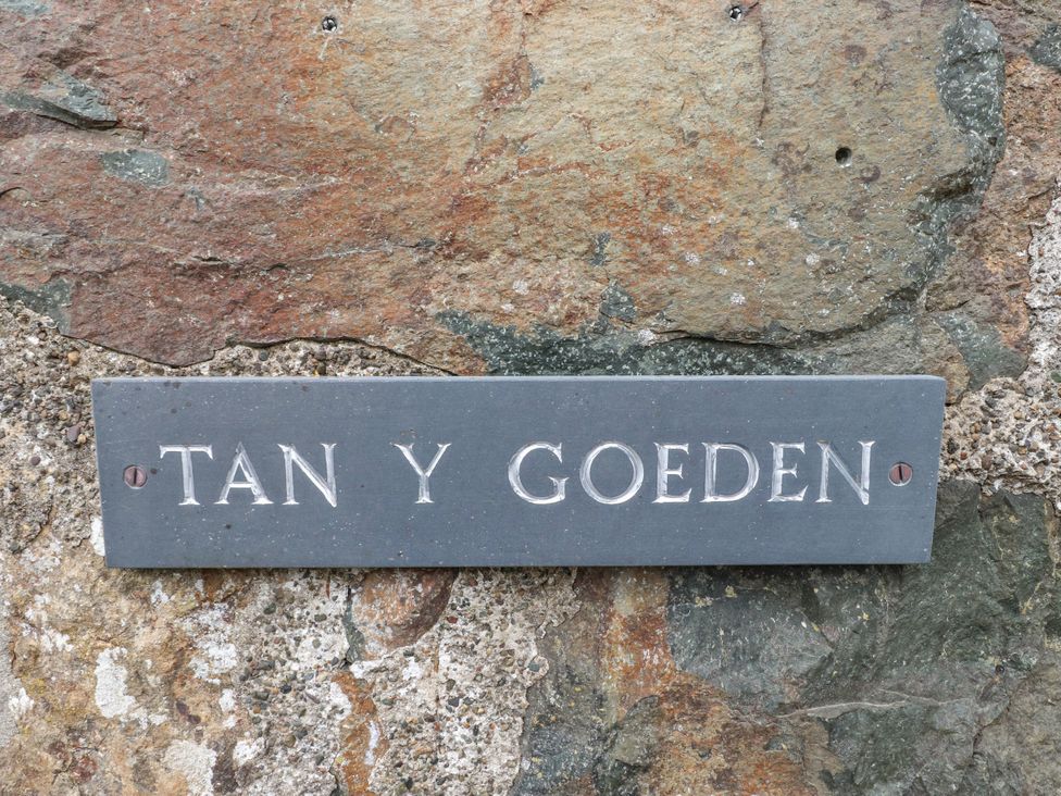 A sign for Tan Y Goeden on a stone wall at Tan Y Goeden in Morfa Nefyn