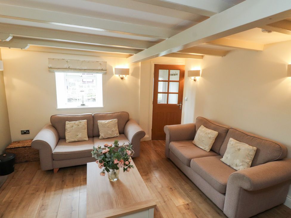 A living room with two sofas and a coffee table at Tan Y Goeden in Morfa Nefyn