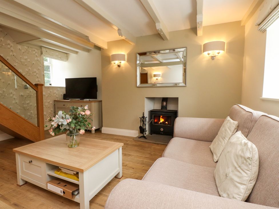 A living room with a sofa and television at Tan Y Goeden in Morfa Nefyn