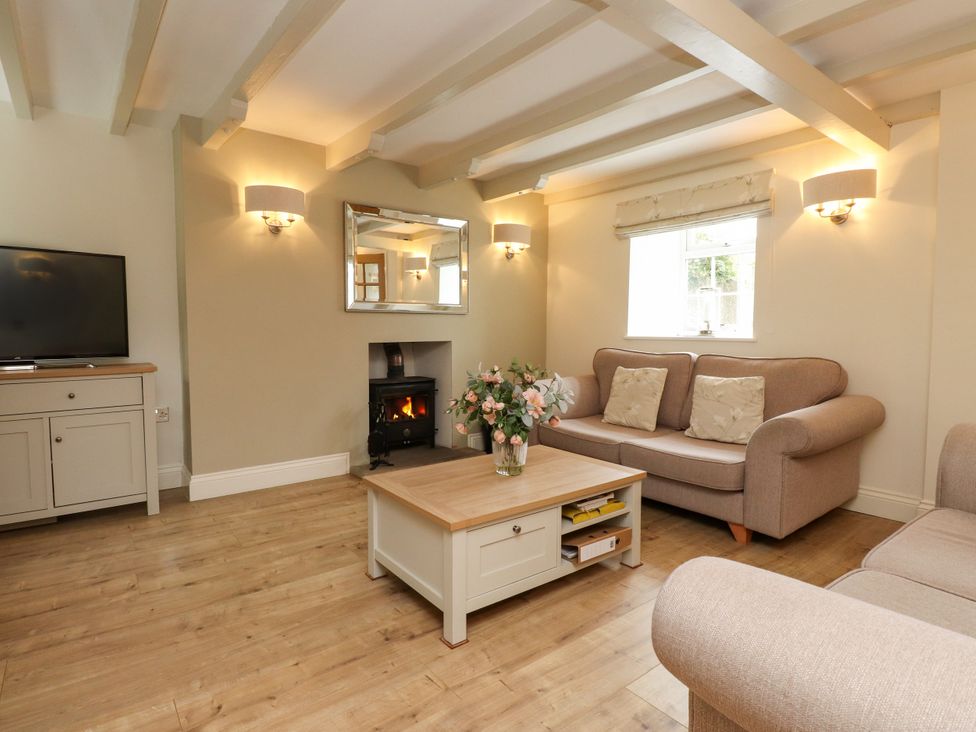 A living room with a sofa and television at Tan Y Goeden in Morfa Nefyn