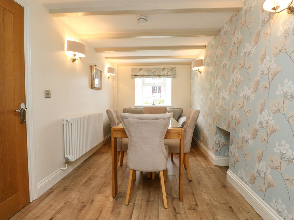 A dining room with a table and chairs at Tan Y Goeden in Morfa Nefyn