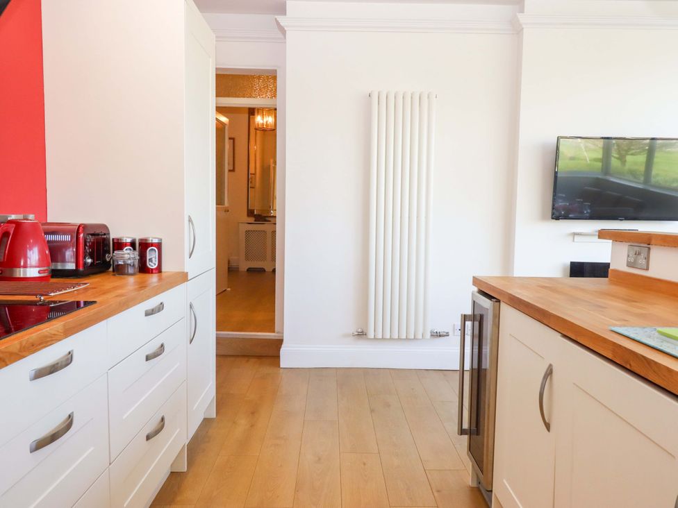 A kitchen with appliances and cabinetry at Avenue Park Villa in Torquay