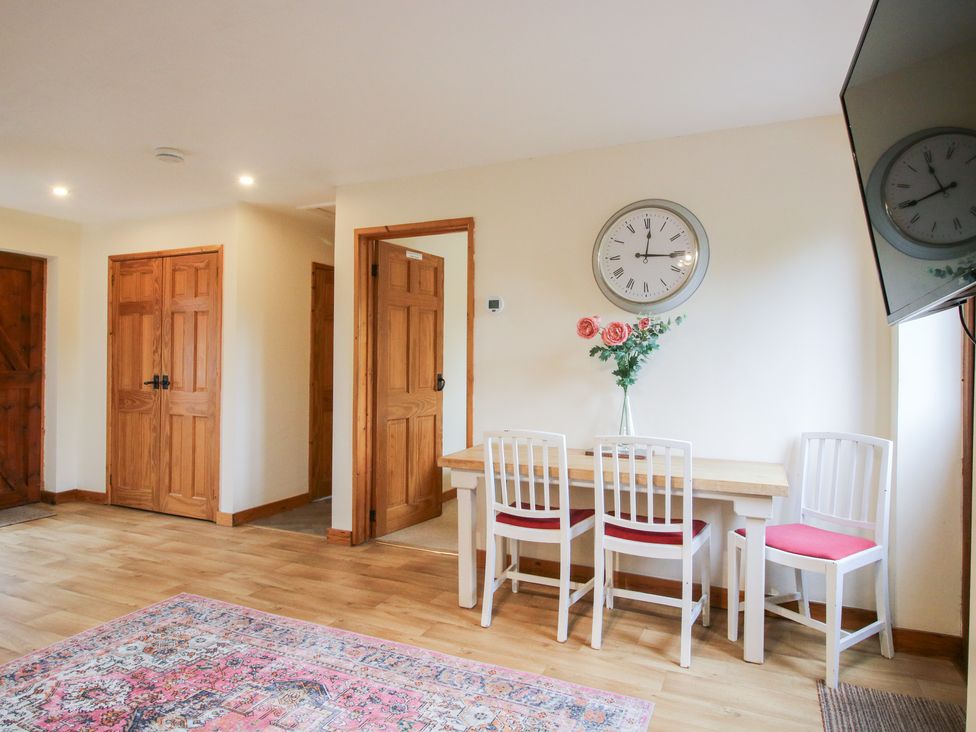 A dining room with a table and chairs at Old Hall Barn 1 Church Stretton