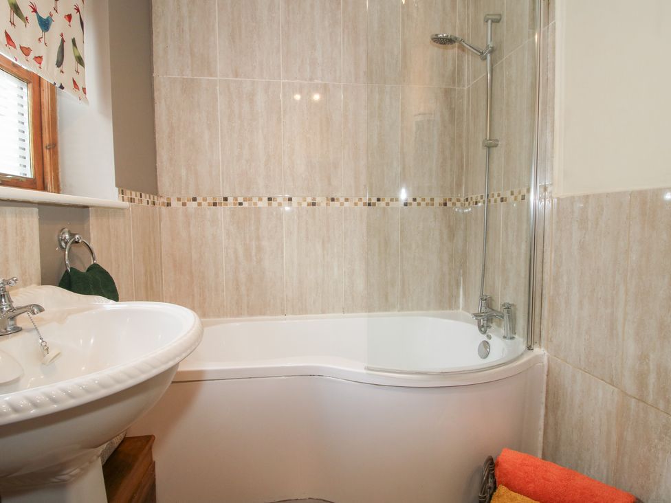 A bathroom with a bathtub and a sink at Old Hall Barn 1, Church Stretton