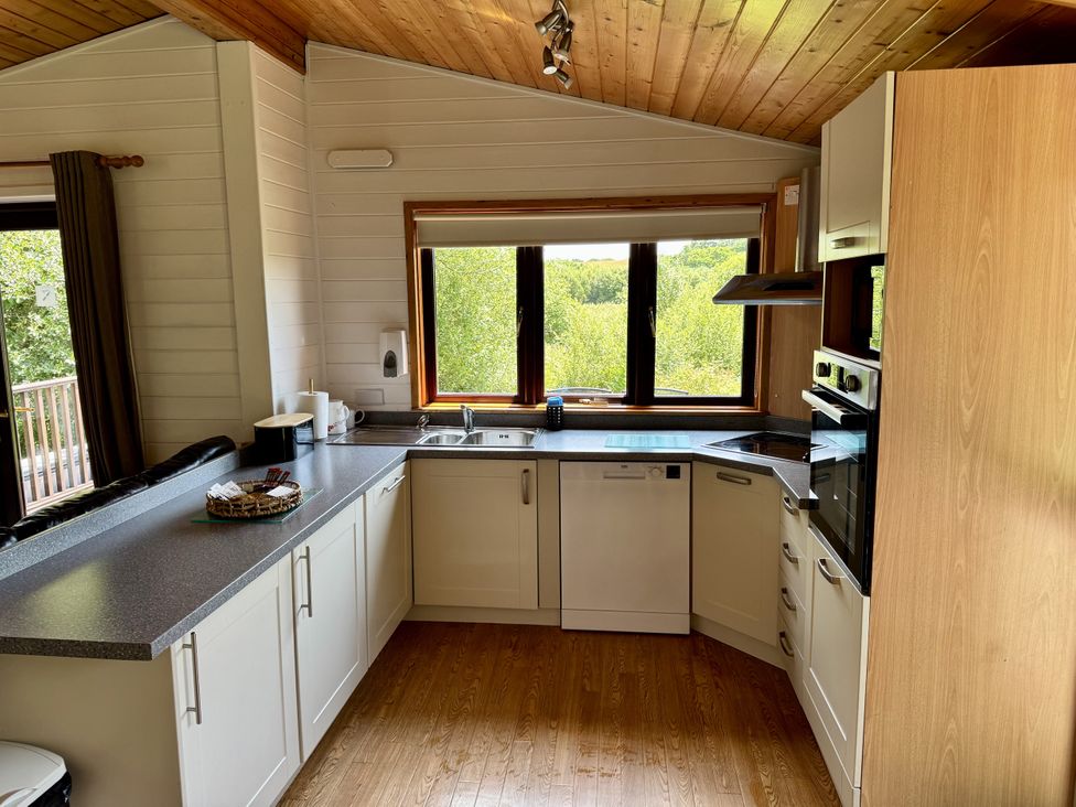 A kitchen with a sink and window at Willow Lodge Constantine near Falmouth