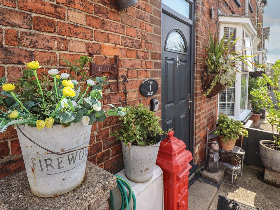 An entrance with planters and a red post box at 1 The Bays Burgh Le Marsh