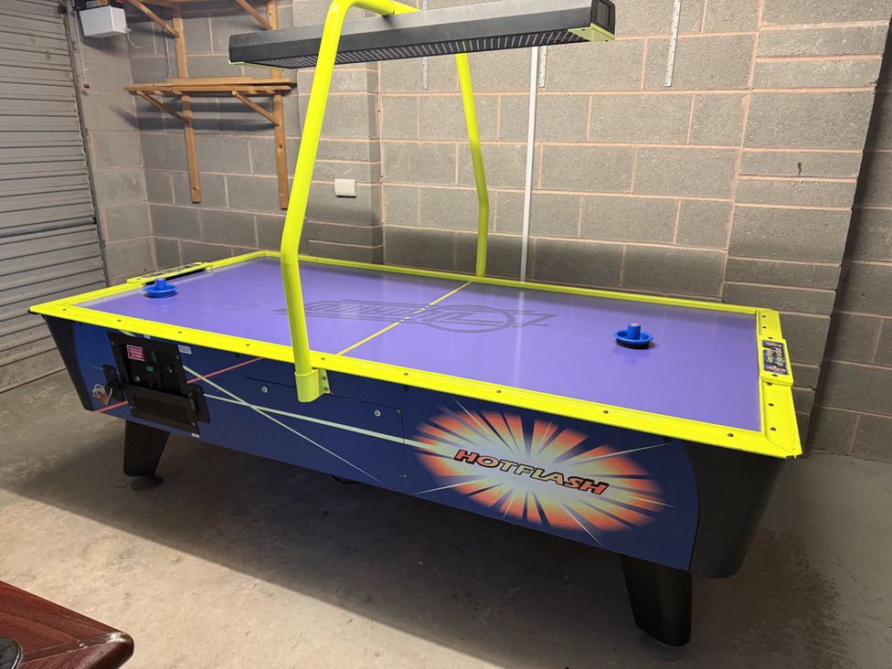 An air hockey table in a game room at Westpoint Llandudno