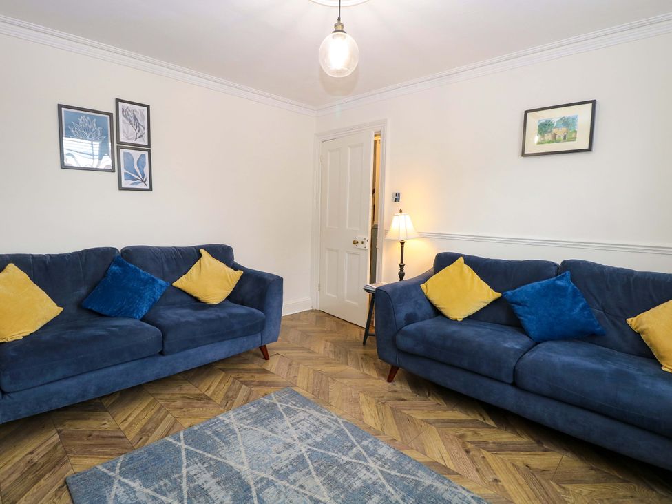 A living room with two sofas and a lamp at Springfield in Hempton near Fakenham