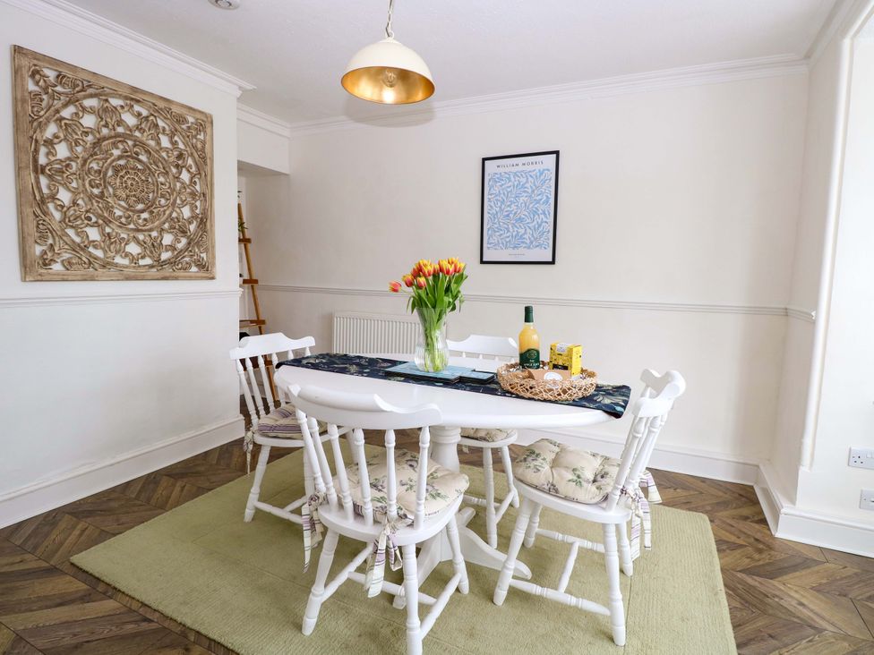 A dining room with a table and chairs at Springfield in Hempton near Fakenham
