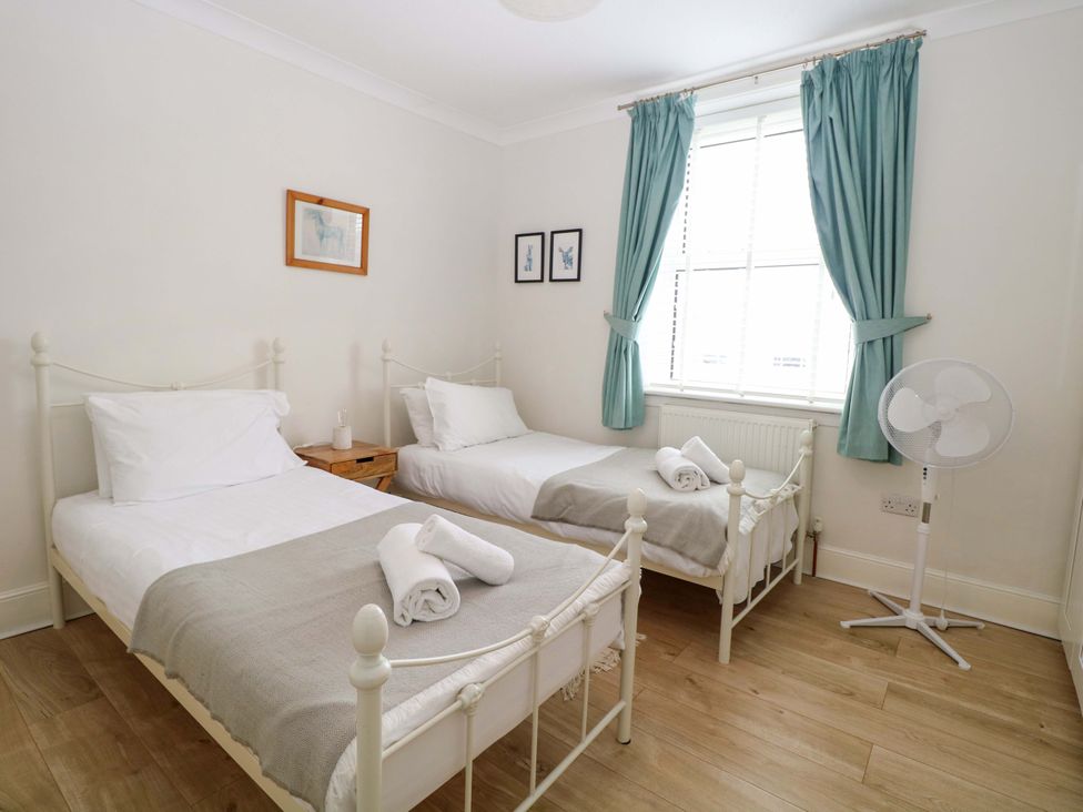 A bedroom with two beds and a fan at Springfield in Hempton near Fakenham