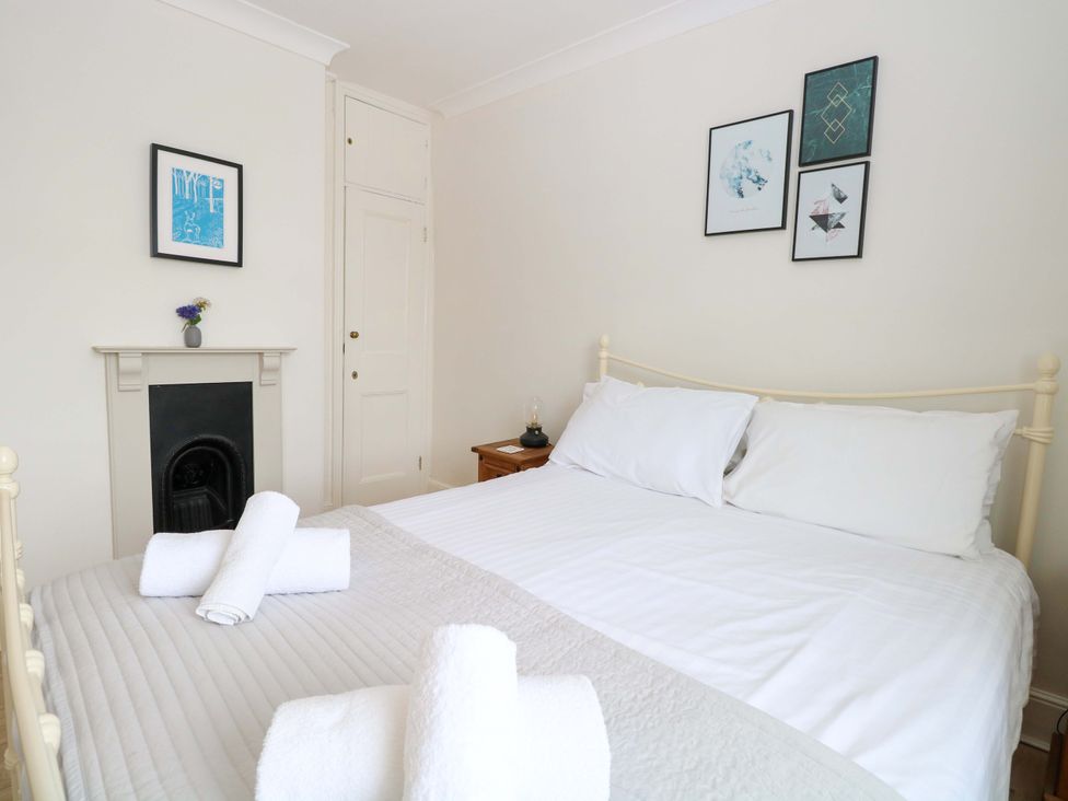 A bedroom with a bed and artwork on the wall at Springfield in Hempton near Fakenham