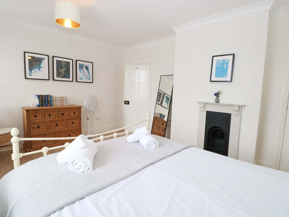 A bedroom with a bed and chest of drawers at Springfield in Hempton near Fakenham