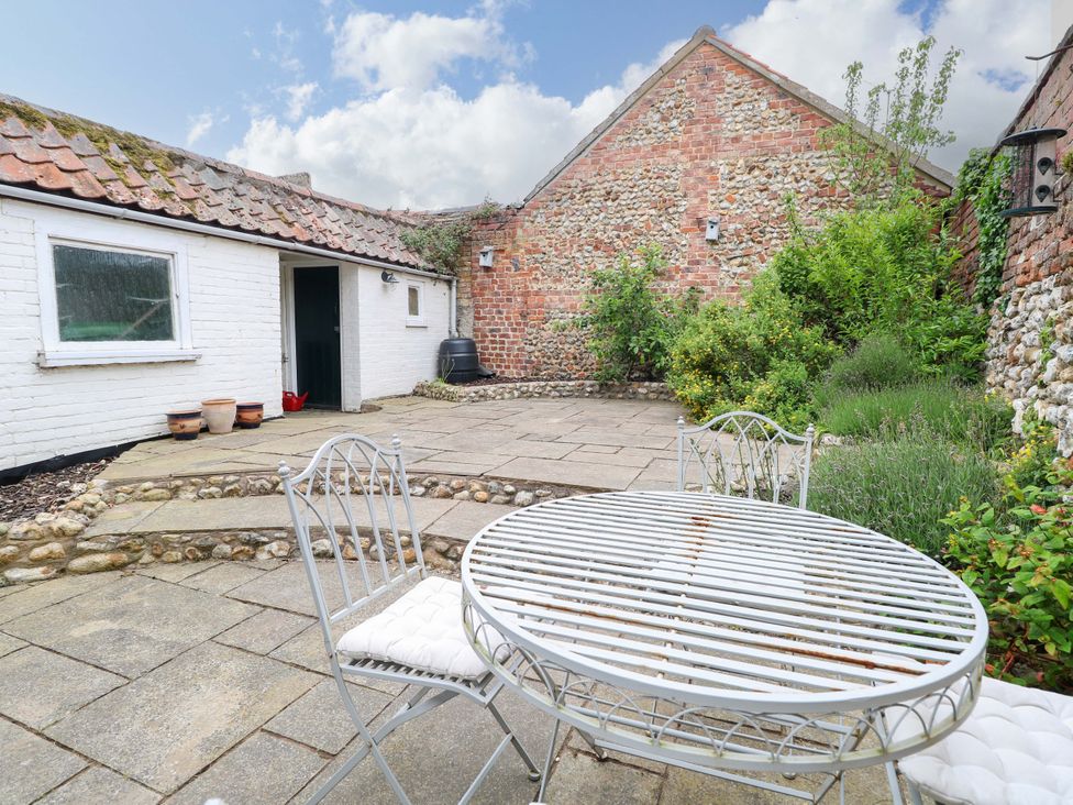 A garden with a table and chairs at Springfield in Hempton near Fakenham