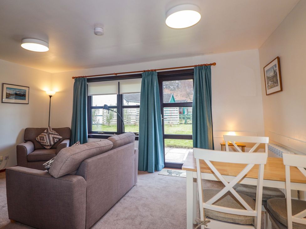 A living room with sofa and dining table at Church House Poolewe