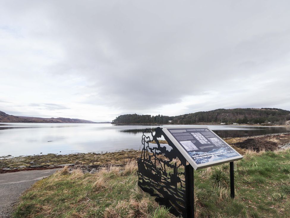 A scenic view with an information sign by a body of water at Church House Poolewe
