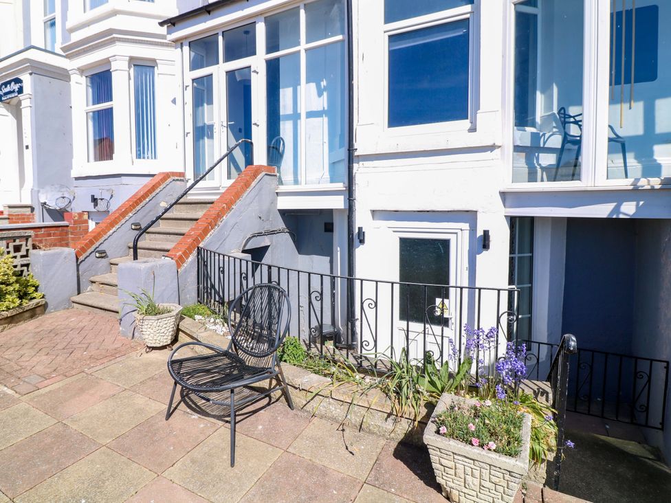 An outdoor area with stairs, a chair, and planters at Apt 5 @ Hunter's Quay in Bridlington