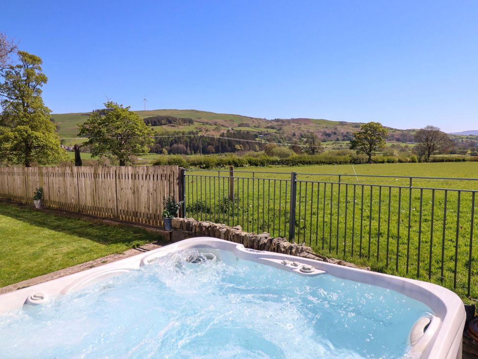 An outdoor area with a hot tub and view of the countryside at Cefn Nannau near Ty-nant Cerrigydrudion