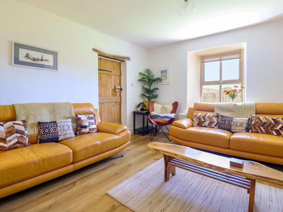 A living room with sofas and a coffee table at Cefn Nannau near Ty-nant near Cerrigydrudion