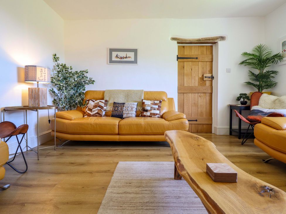 A living room with a sofa and coffee table at Cefn Nannau Ty-nant near Cerrigydrudion