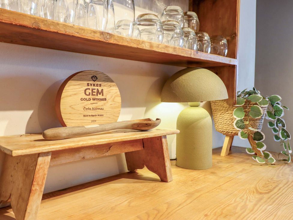 A shelf with glasses and an award at Cefn Nannau in Ty-nant near Cerrigydrudion