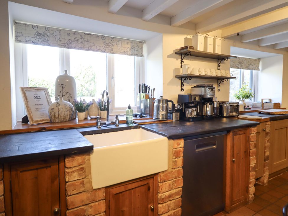A kitchen with a sink and various appliances at Cefn Nannau Ty-nant near Cerrigydrudion