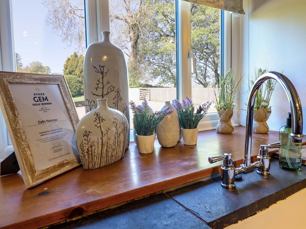 A kitchen sink area with vases and an award certificate at Cefn Nannau near Cerrigydrudion