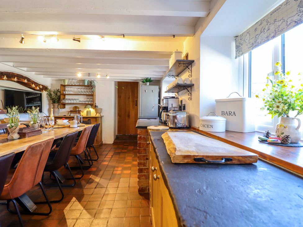A kitchen with a large table and chairs at Cefn Nannau near Ty-nant Cerrigydrudion