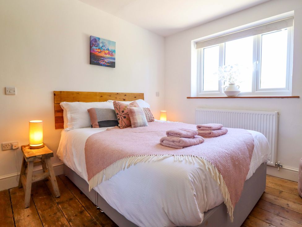 A bedroom with a bed and nightstand at Cefn Nannau near Ty-nant Cerrigydrudion