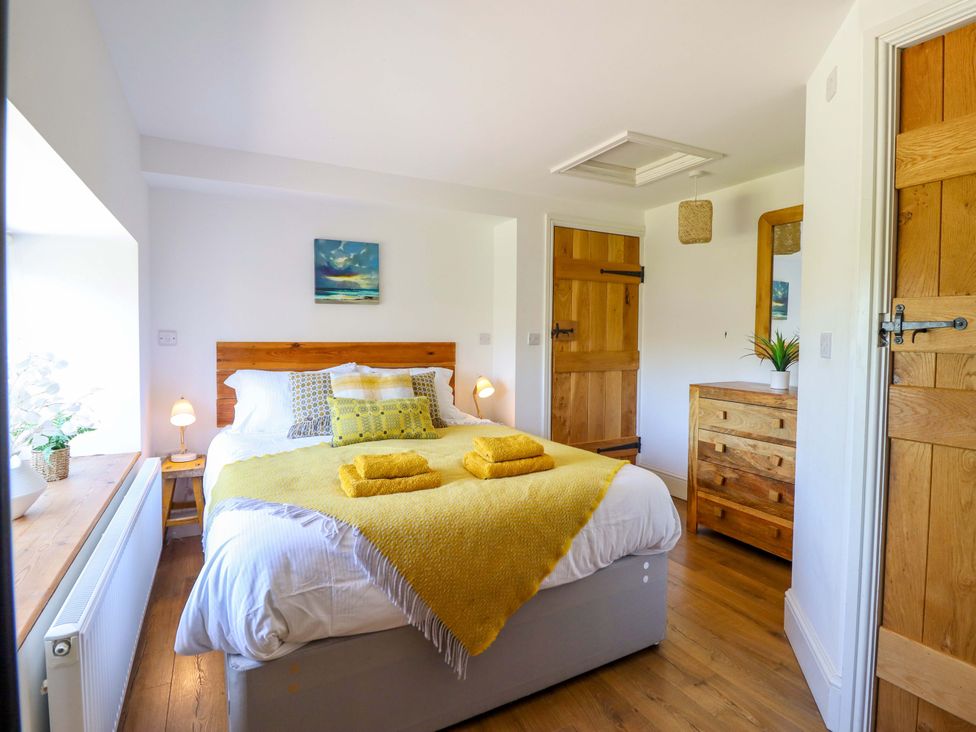A bedroom with a bed and wooden furniture at Cefn Nannau near Ty-nant Cerrigydrudion