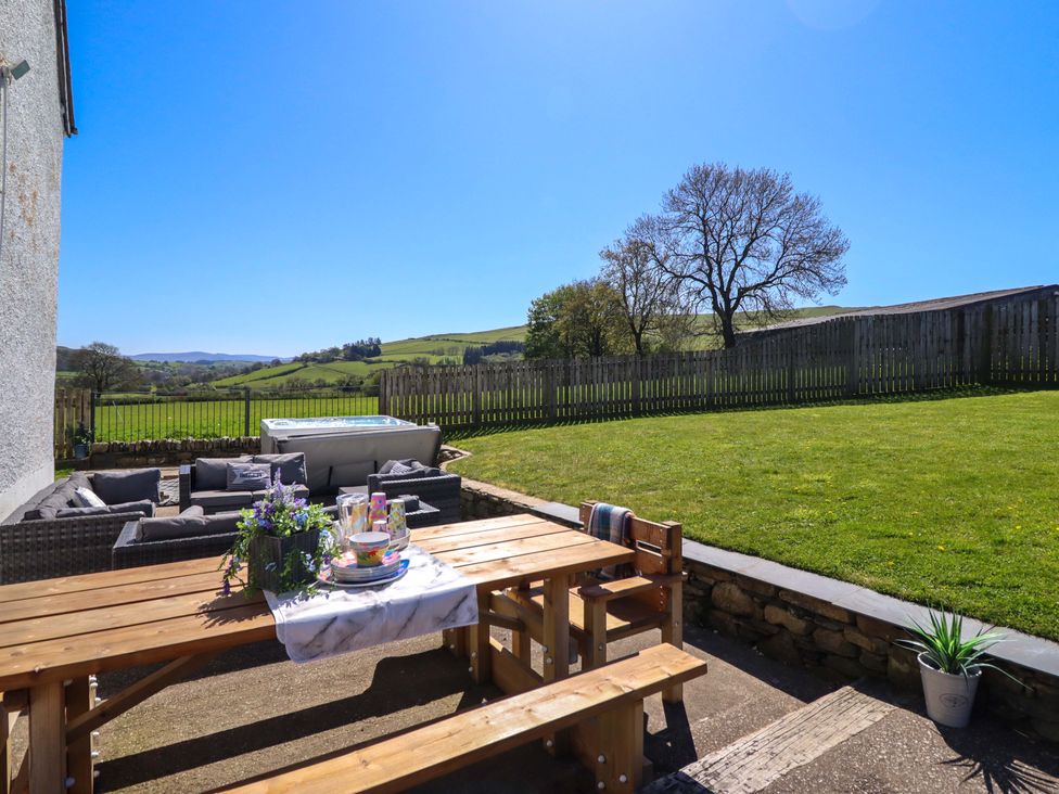 An outdoor space with a table and chairs at Cefn Nannau Ty-nant near Cerrigydrudion