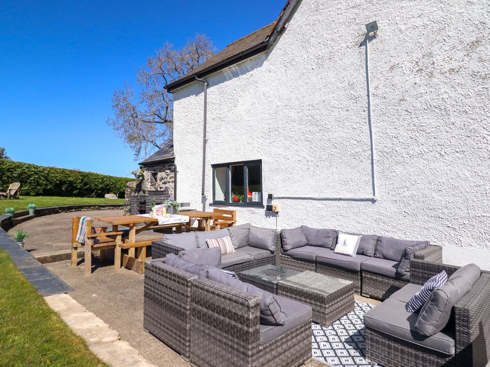 An outdoor patio with seating and dining arrangements at Cefn Nannau Ty-nant near Cerrigydrudion