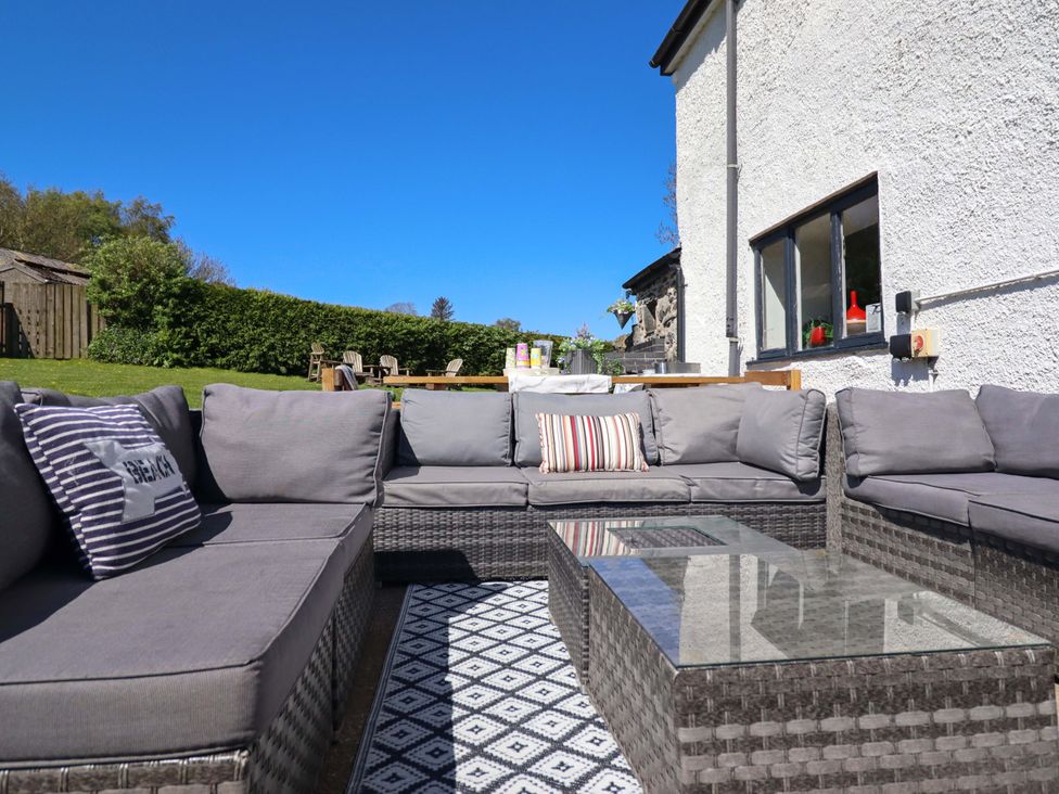 A garden space with outdoor sofa and coffee table at Cefn Nannau near Ty-nant Cerrigydrudion
