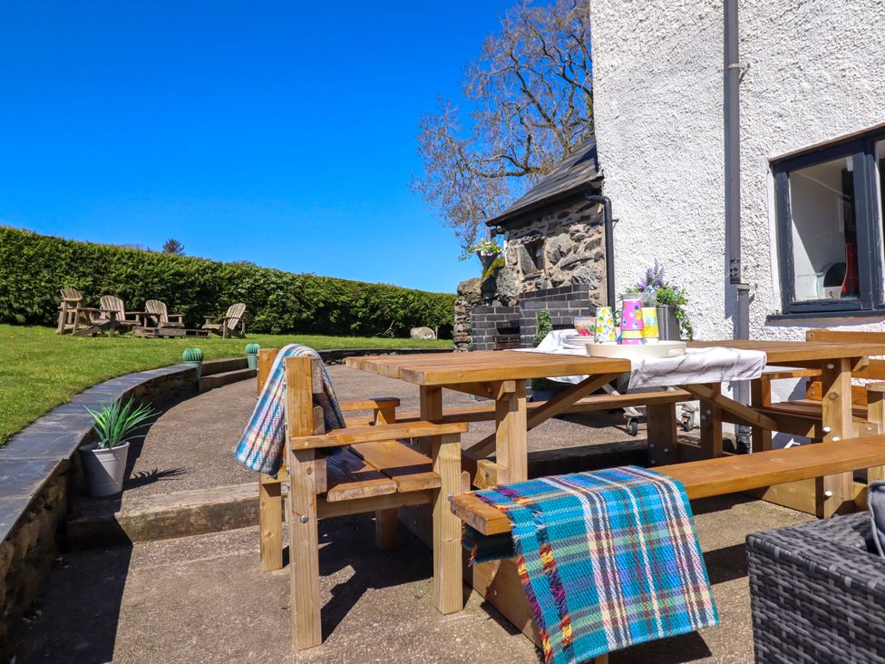 An outdoor area with a wooden table and benches at Cefn Nannau near Ty-nant Cerrigydrudion