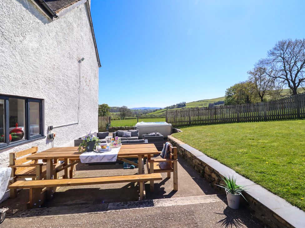 An outdoor space with a dining table and seating area at Cefn Nannau Ty-nant near Cerrigydrudion