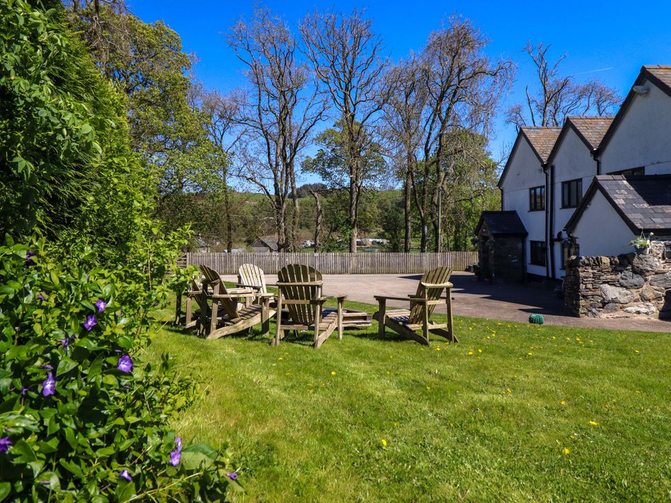 A garden with chairs and a table at Cefn Nannau Ty-nant near Cerrigydrudion