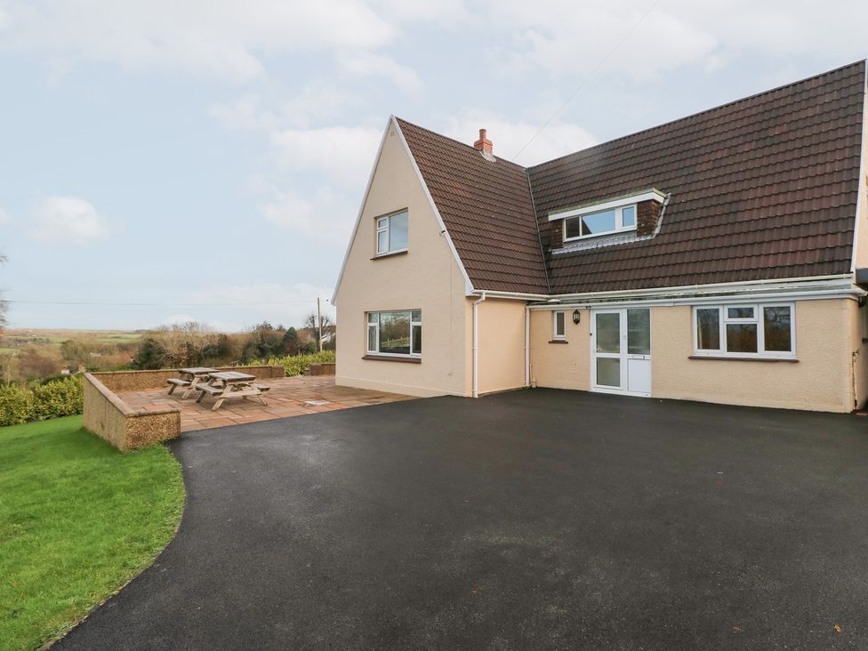 A house with a garden and patio furniture at Cherry Trees in Haverfordwest