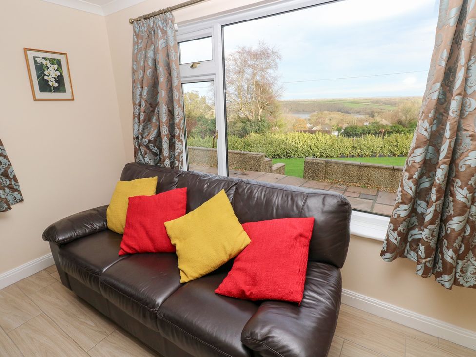 A living room with a sofa and view at Cherry Trees in Haverfordwest