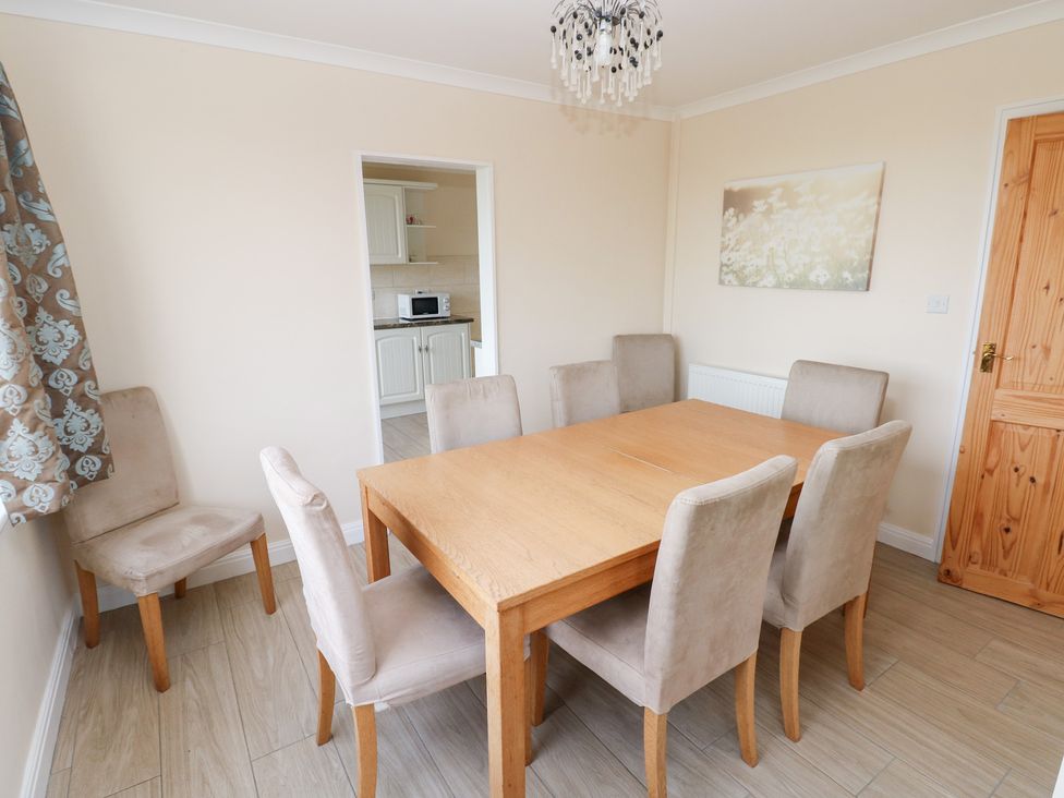 A dining room with a table and chairs at Cherry Trees in Haverfordwest