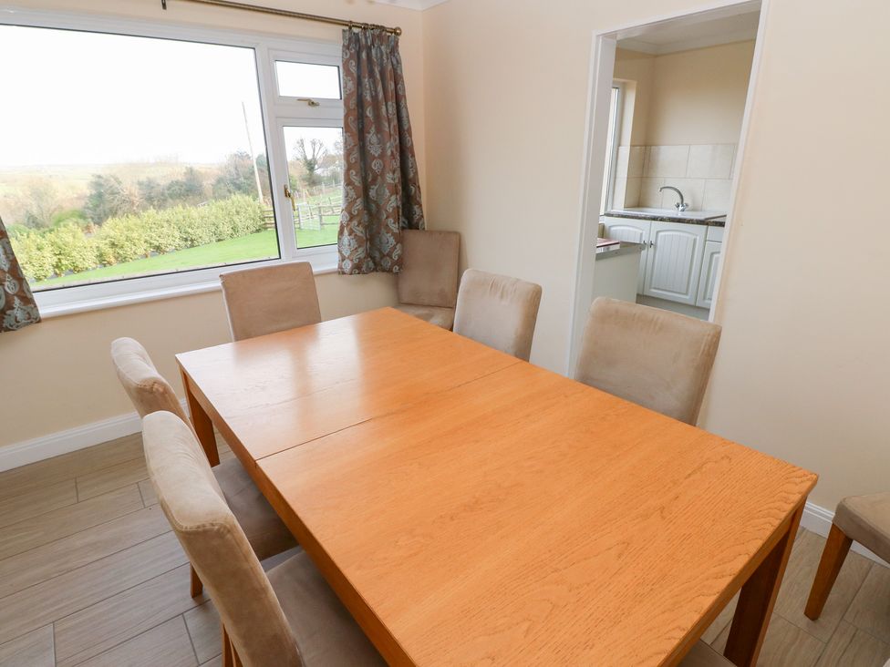A dining room with a table and chairs at Cherry Trees in Haverfordwest