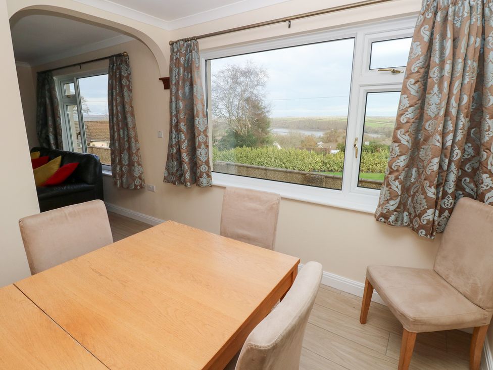 A dining room with a table and chairs at Cherry Trees in Haverfordwest