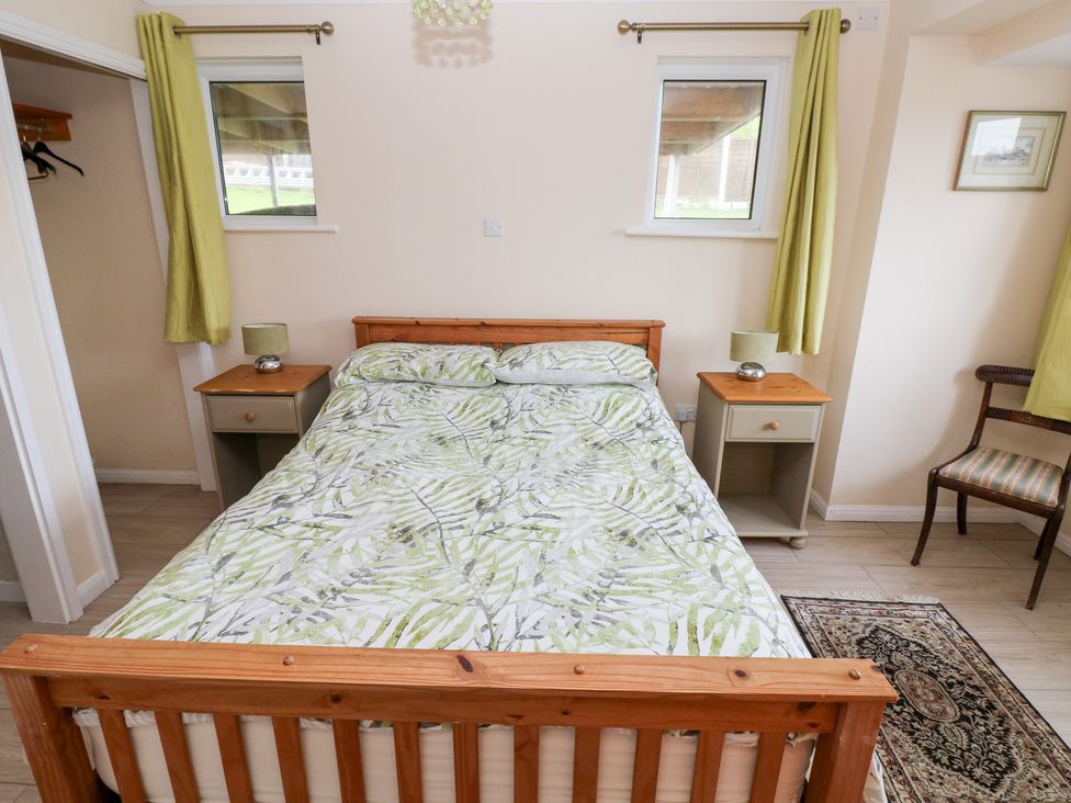 A bedroom with a bed and bedside tables at Cherry Trees in Haverfordwest