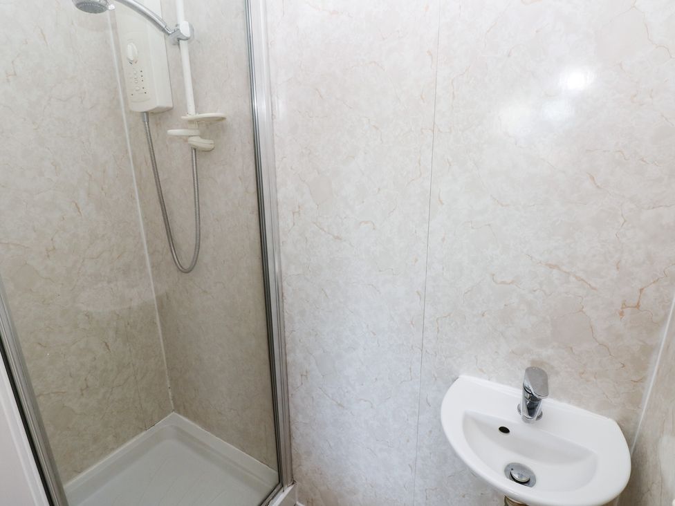 A bathroom with a shower and a sink at Cherry Trees in Haverfordwest