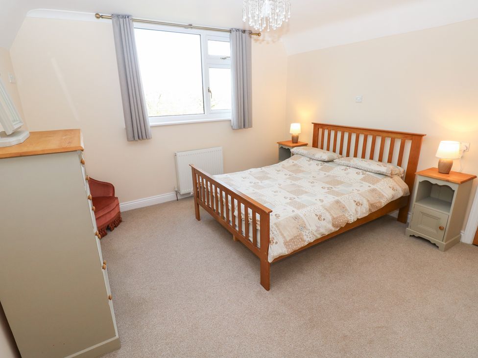 A bedroom with a bed and side tables at Cherry Trees in Haverfordwest