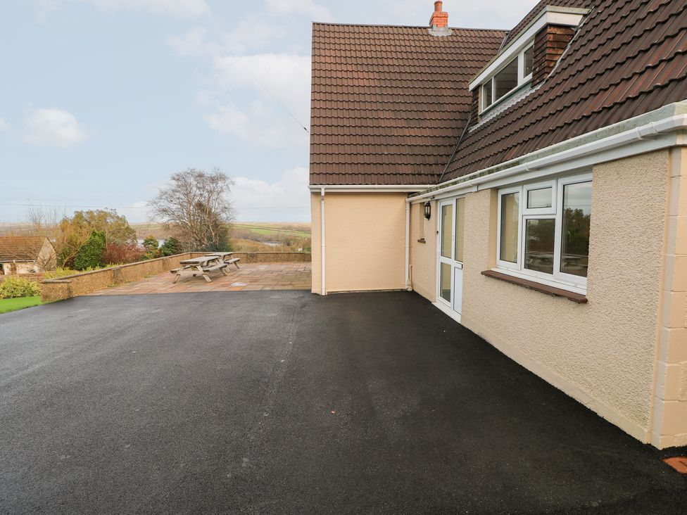 A house exterior with a patio area and table at Cherry Trees Haverfordwest