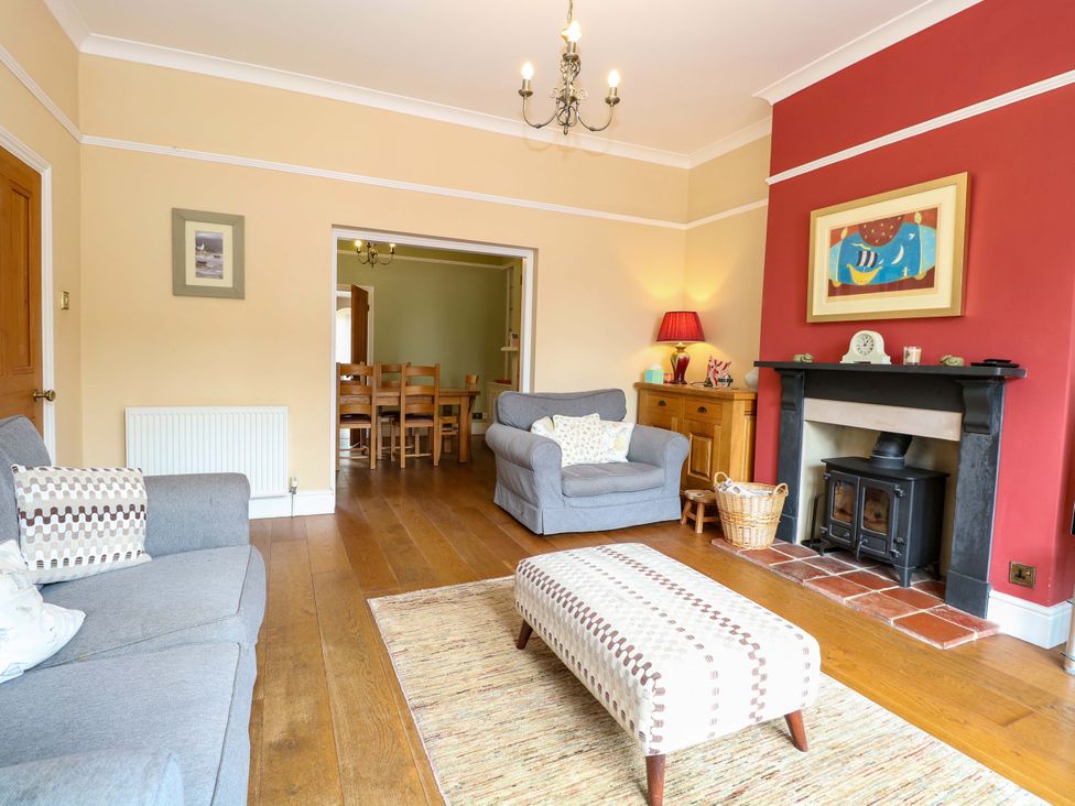 A living room with a sofa and fireplace at Tilly's Retreat in Hunstanton