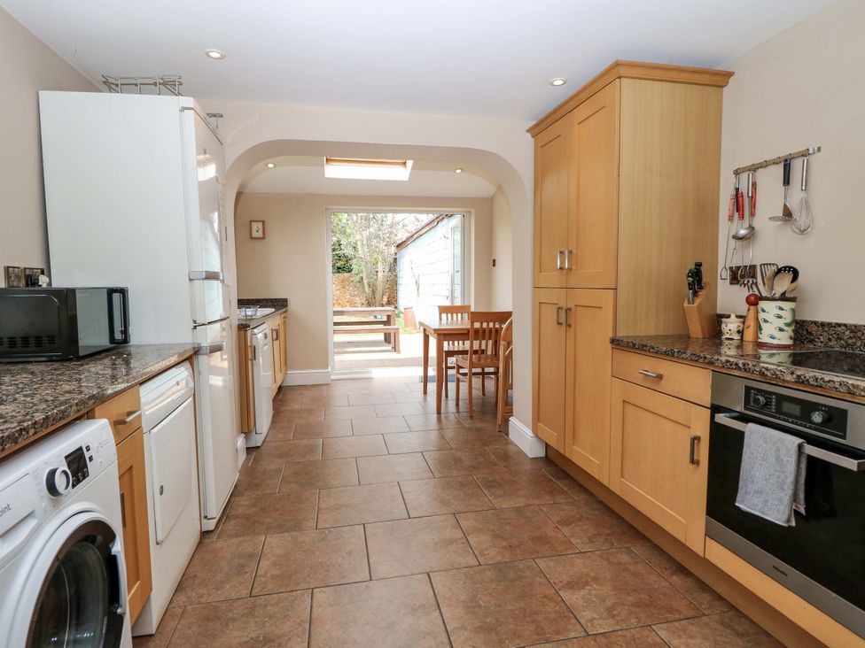 A kitchen with appliances and dining area at Tilly's Retreat in Hunstanton