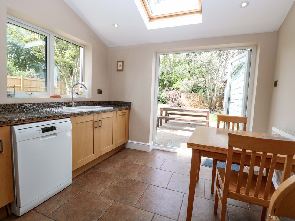 A kitchen with sink and table at Tilly's Retreat in Hunstanton
