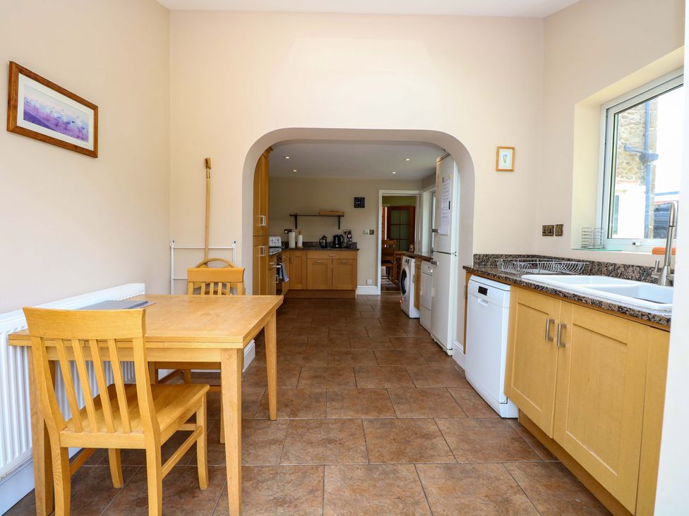 A kitchen with a table and chairs at Tilly's Retreat in Hunstanton
