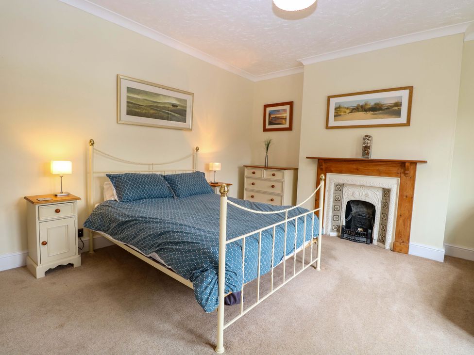 A bedroom with a bed and bedside tables at Tilly's Retreat in Hunstanton